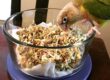 Pineapple green-cheeked conure eating BBFE sprouts.